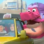 The Wish Dragon sticks his head out of a taxi like a dog.